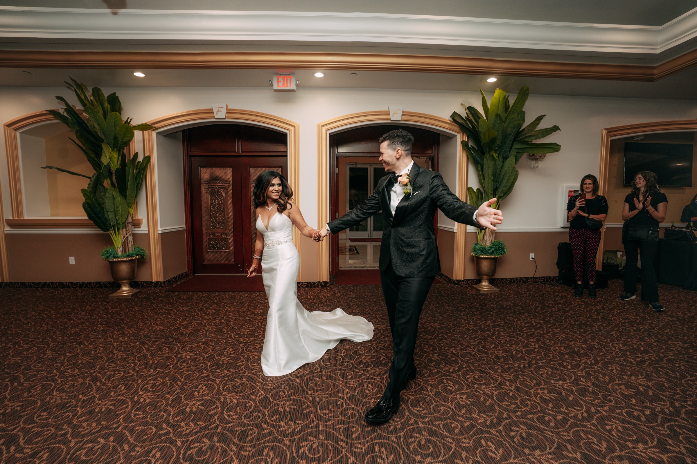 The couple entering their wedding celebration