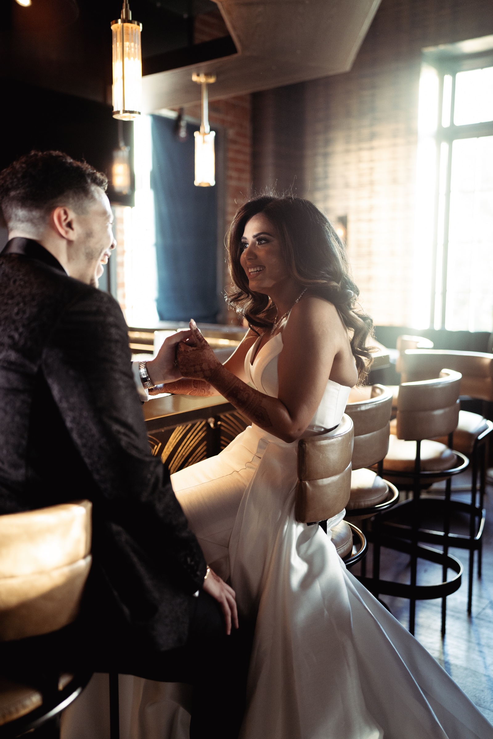 The bride smiling at the groom in the bar